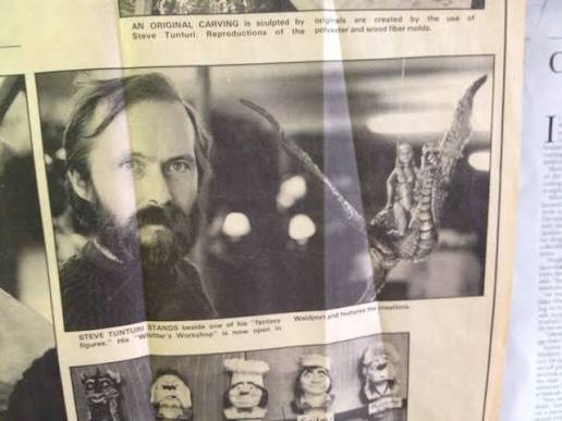 Steve Tunturi pictured in a newspaper clipping beside a fantasy sculpture.